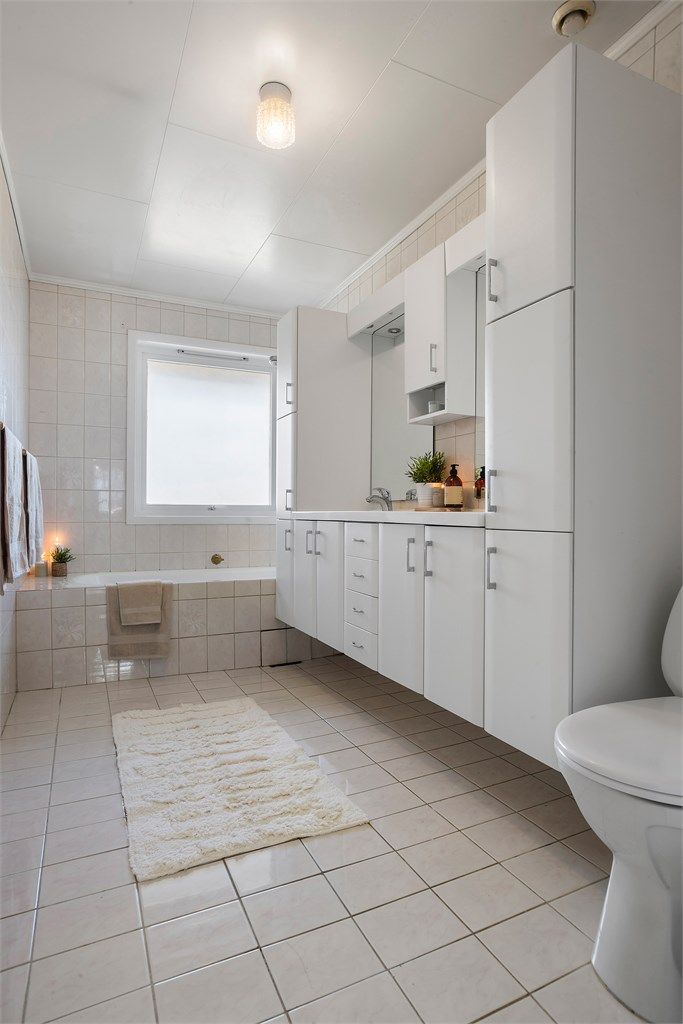 Badet er utstyrt med badekar, dobbel servant, rikelig med skapplass og gulvmontert toalett. 