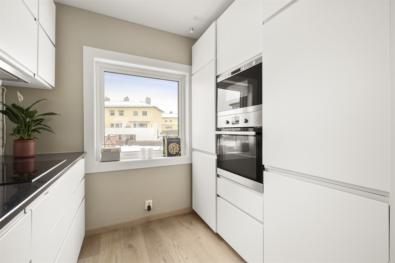 Fra kjøkkenet er det utsyn rett på fellesarealene og lekeplassen. 