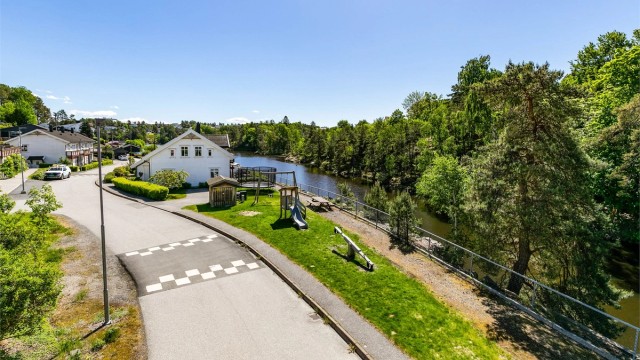 Rett over gaten finnes både lekeplass og en idyllisk turvei langs elva.