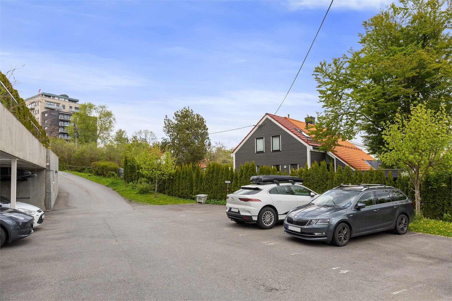 Det medfølger en parkeringsplass med ladeboks i carport, samt en parkeringsplass under åpen himmel.