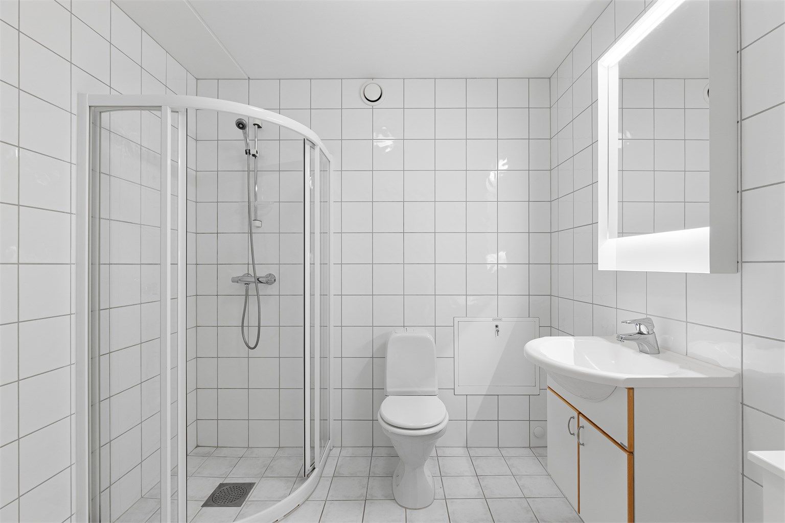 Flislagt baderom fra byggeår med gulvvarme og opplegg for vaskemaskin