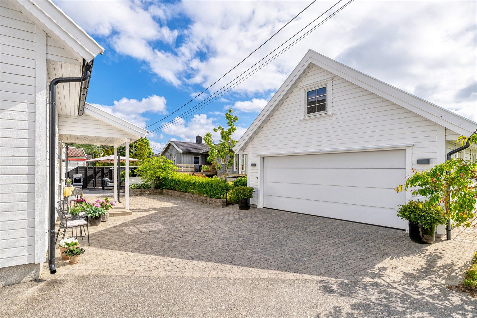 Imøtekommende og hyggelig innkjørsel med belegningsstein,  beplantninger, hekk og overbygd inngangsparti, dobbelgarasje hvor loftet er isolert.