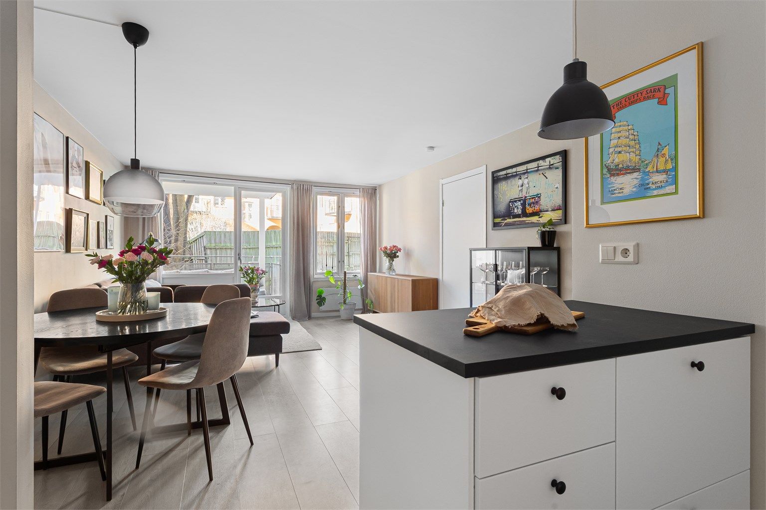  En praktisk halvøy danner et naturlig skille mellom kjøkken og stuen, samtidig som den gir ekstra benke- og arbeidsplass.