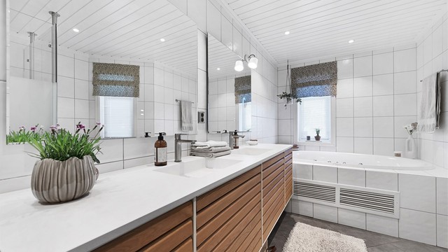 Hovedbadet i første etasje har innredning fra 2021, med doble servanter, innfliset badekar og vannbåren gulvvarme.