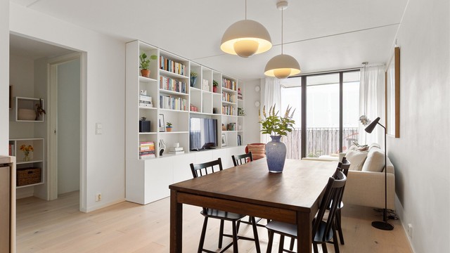 En innbydende og harmonisk stue med plass til både lange middager og late kvelder i sofaen. De gjennomgående, lyse overflatene og den elegante en-stavs parketten gir rommet et moderne og helhetlig uttrykk.