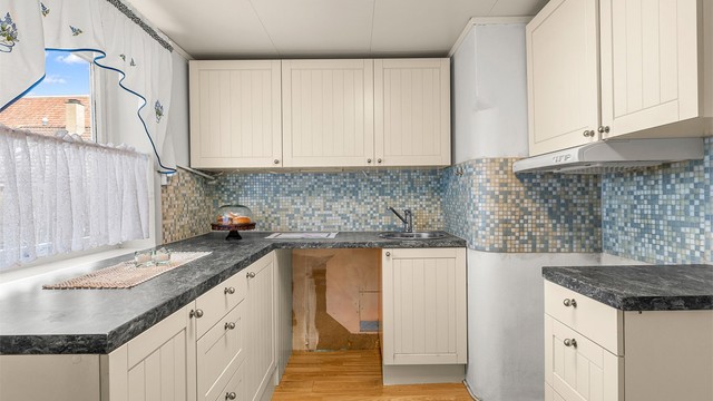 Kjøkkenet i underetasjen har enkel og funksjonell løsning samt rikelig med skap- og benkeplass.