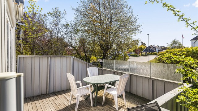 Terrassen strekker seg videre ut i en åpen del med tredekke og plass til sittegruppe.