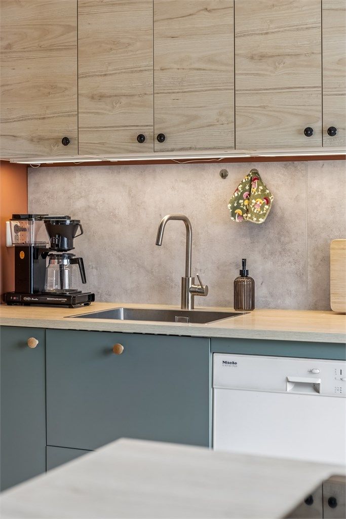  Det er montert laminert plate over kjøkkenbenk, samt belysning og stikkontakter under overskap.