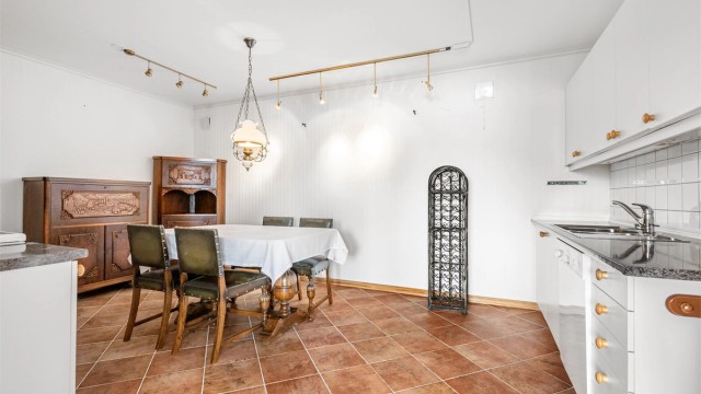 Kjøkkenet i underetasjen har flislagt gulv og plass til spisebord.