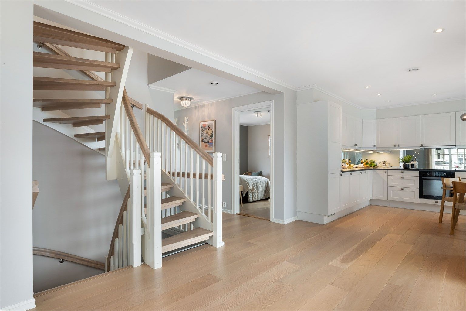 Trappen "glir" fint inn i interiøret med håndløpere og trinn som matcher parketten