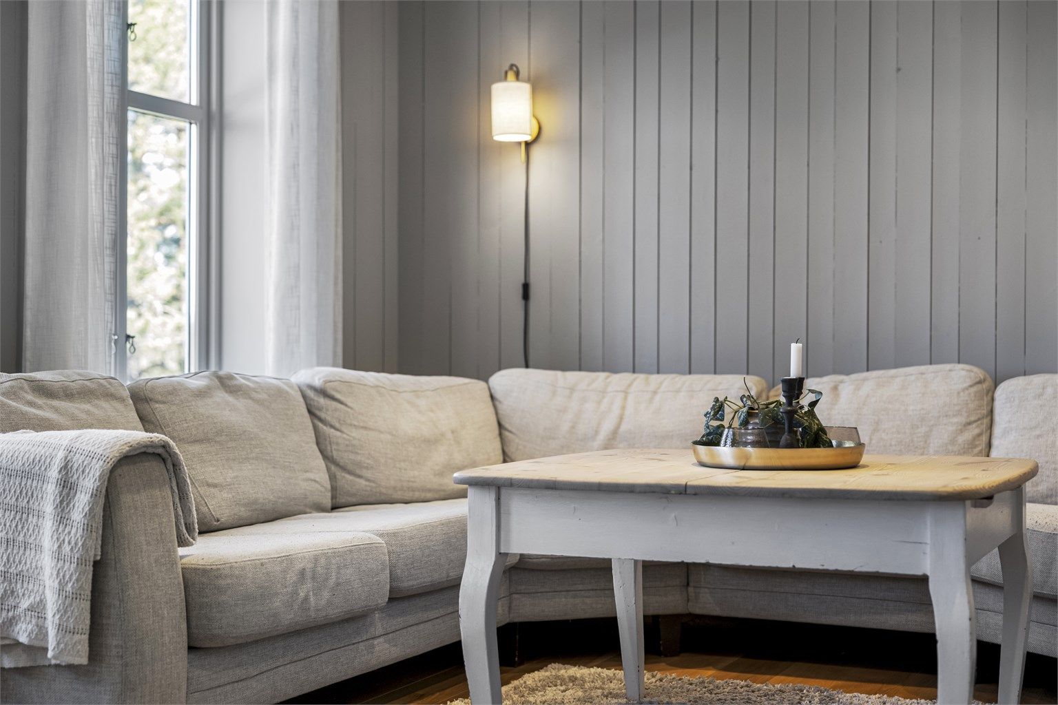 Vegger med malt panel og profilerte innerdører gir boligen en helhetlig stil.