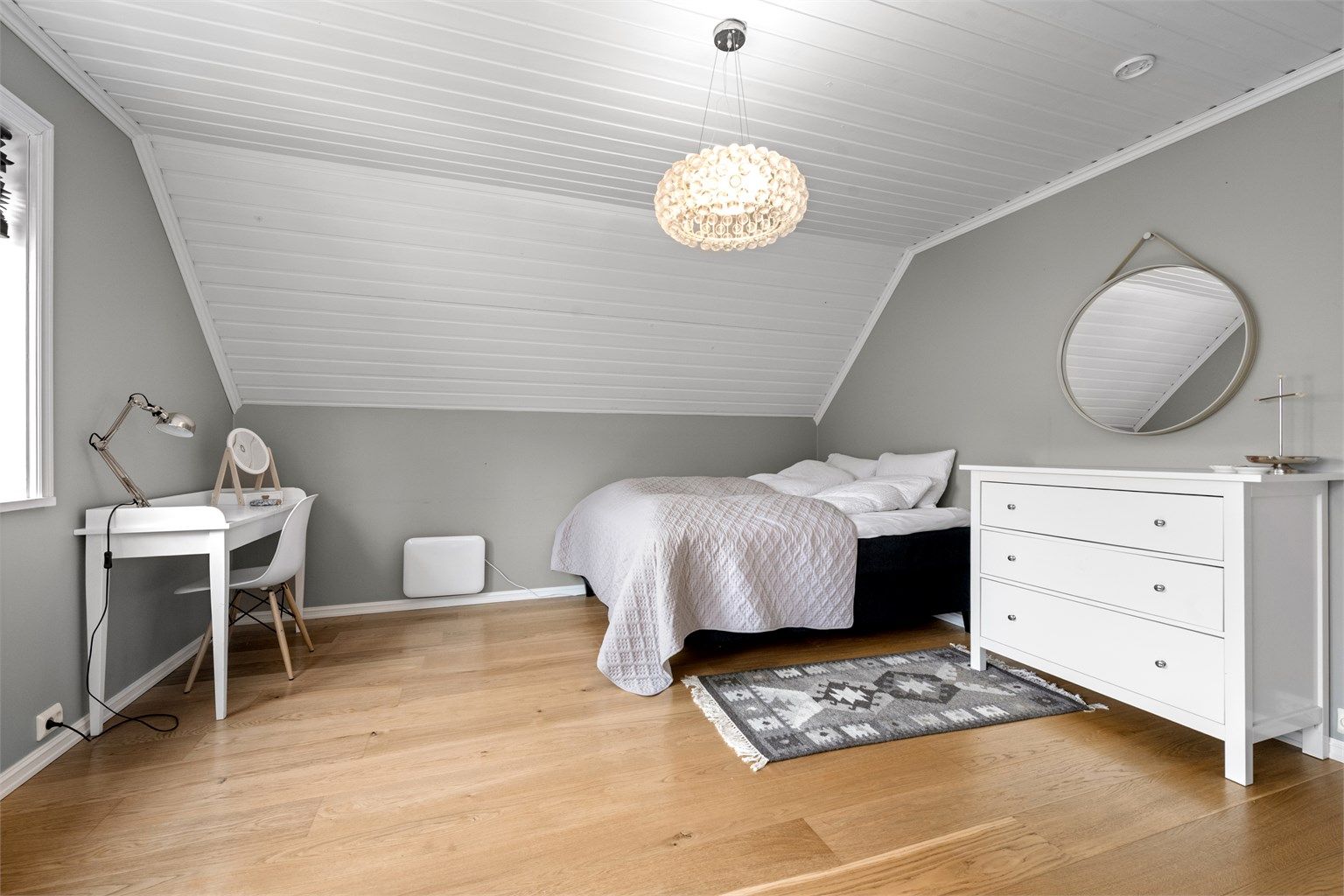 Soverom med god plass til seng og nattbord, samt en liten arbeidsplass.