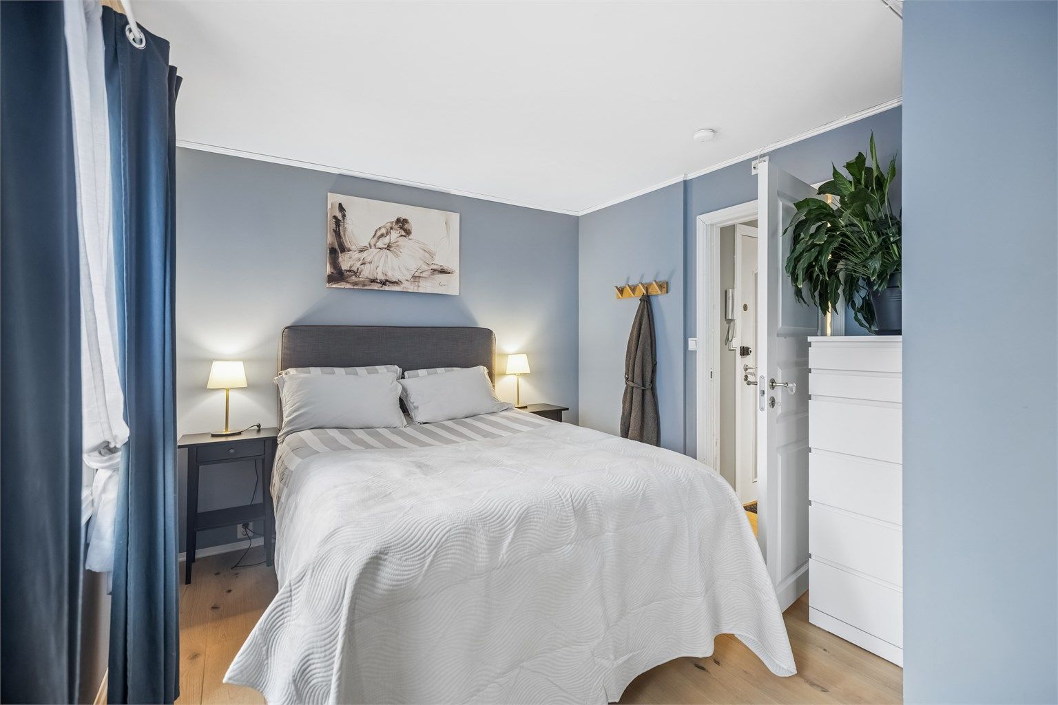 Rommet har god plass til en stor dobbeltseng med tilhørende nattbord.