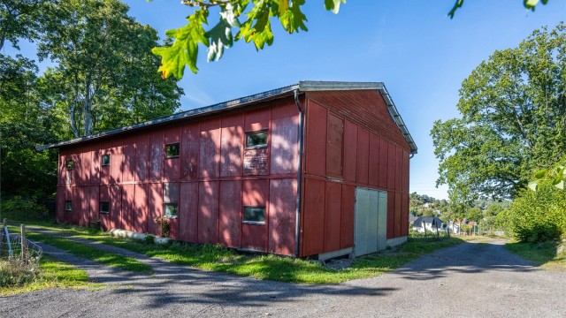 Frittstående lagerhall oppført omkring 1990 med porter og innkjøringsmuligheter.
