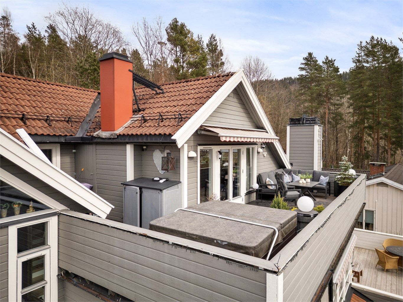 Gulvet på terrassen er belagt med sementbasert puss. Rekkverket er av tre.