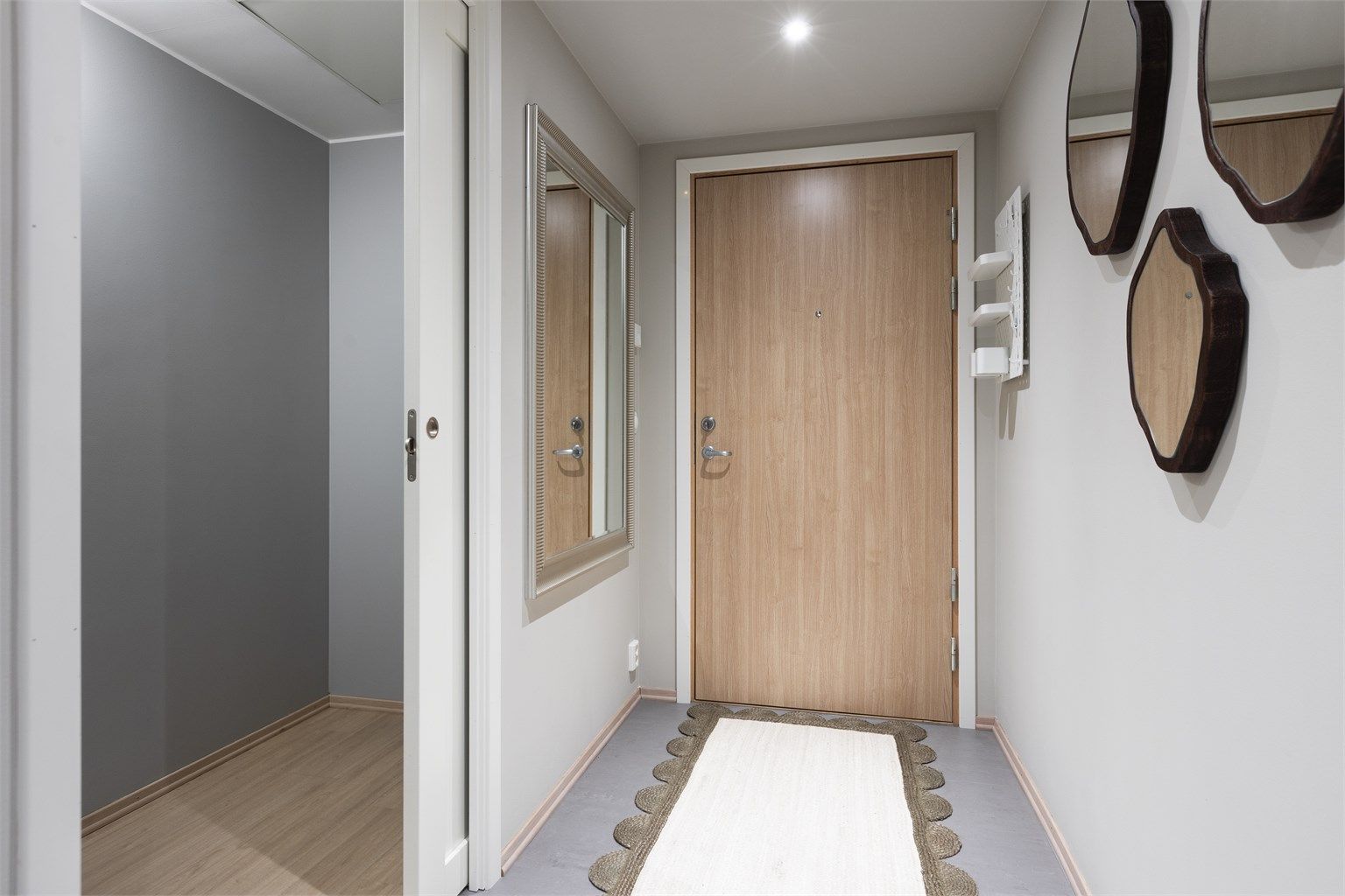 Velkommen inn i en romslig entré med god plass til oppbevaring, i en stor speilgarderobe!