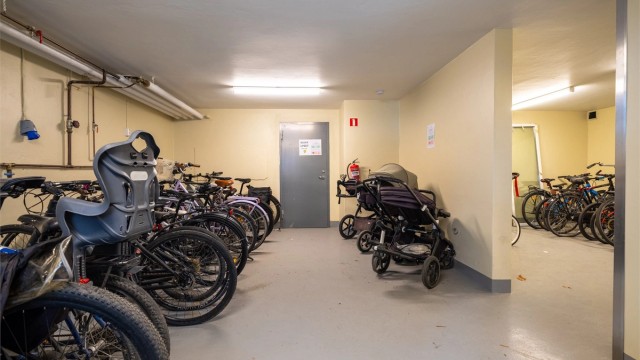 Romslig fellesbod i byggets kjeller med nyetablert sykkel- og barnevognparkering.