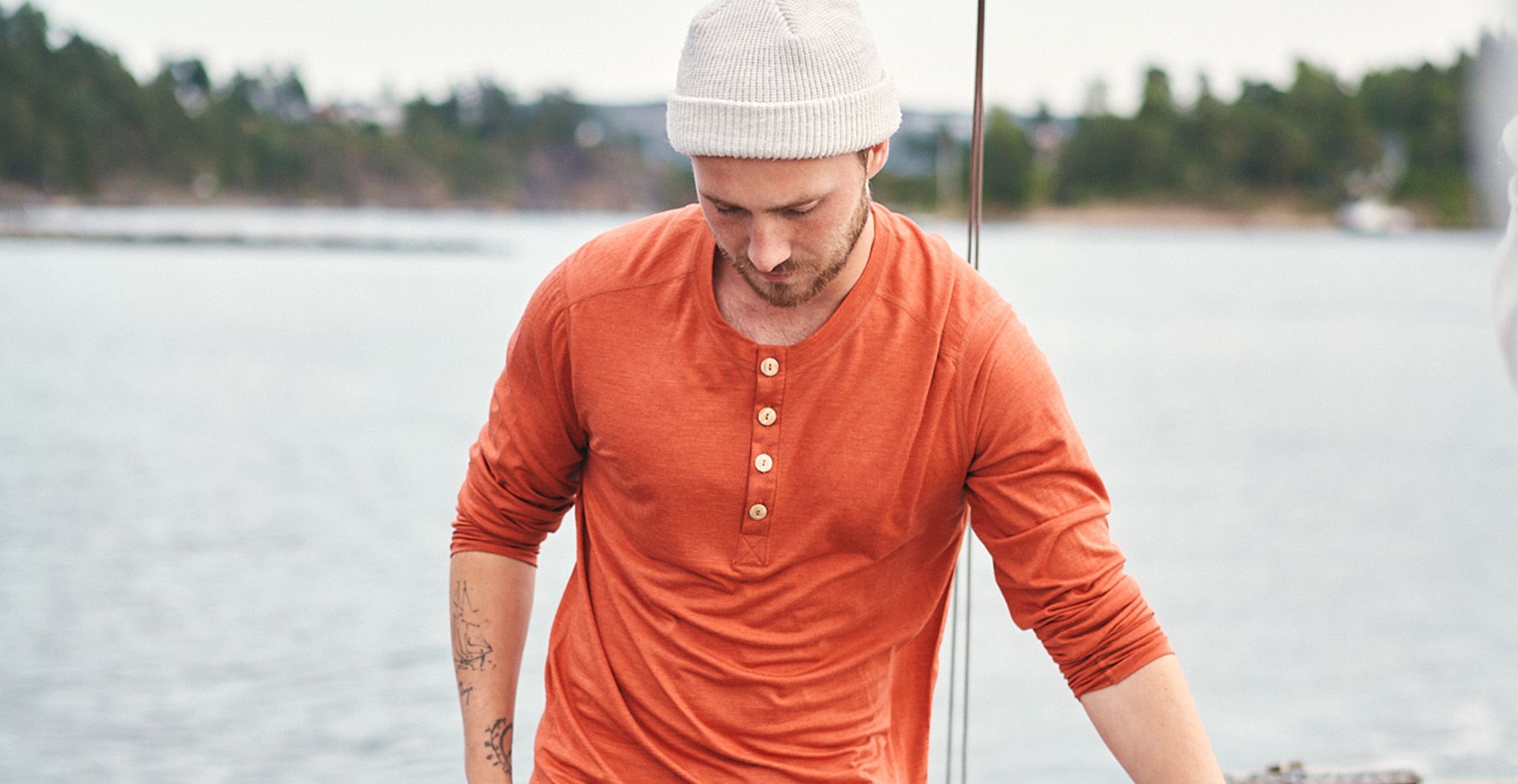 man in a henley shirt on a sail boat