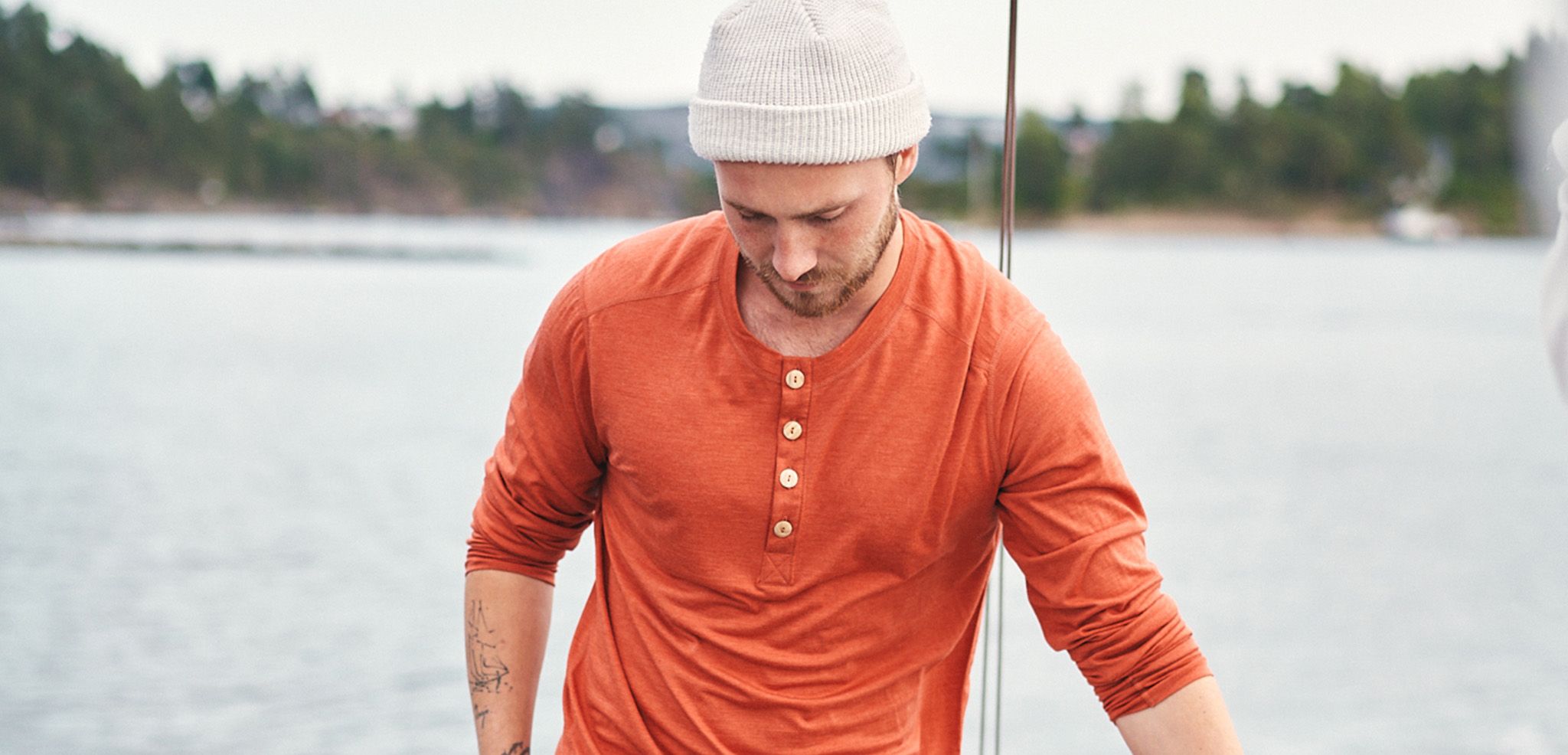 man in a henley shirt on a sail boat