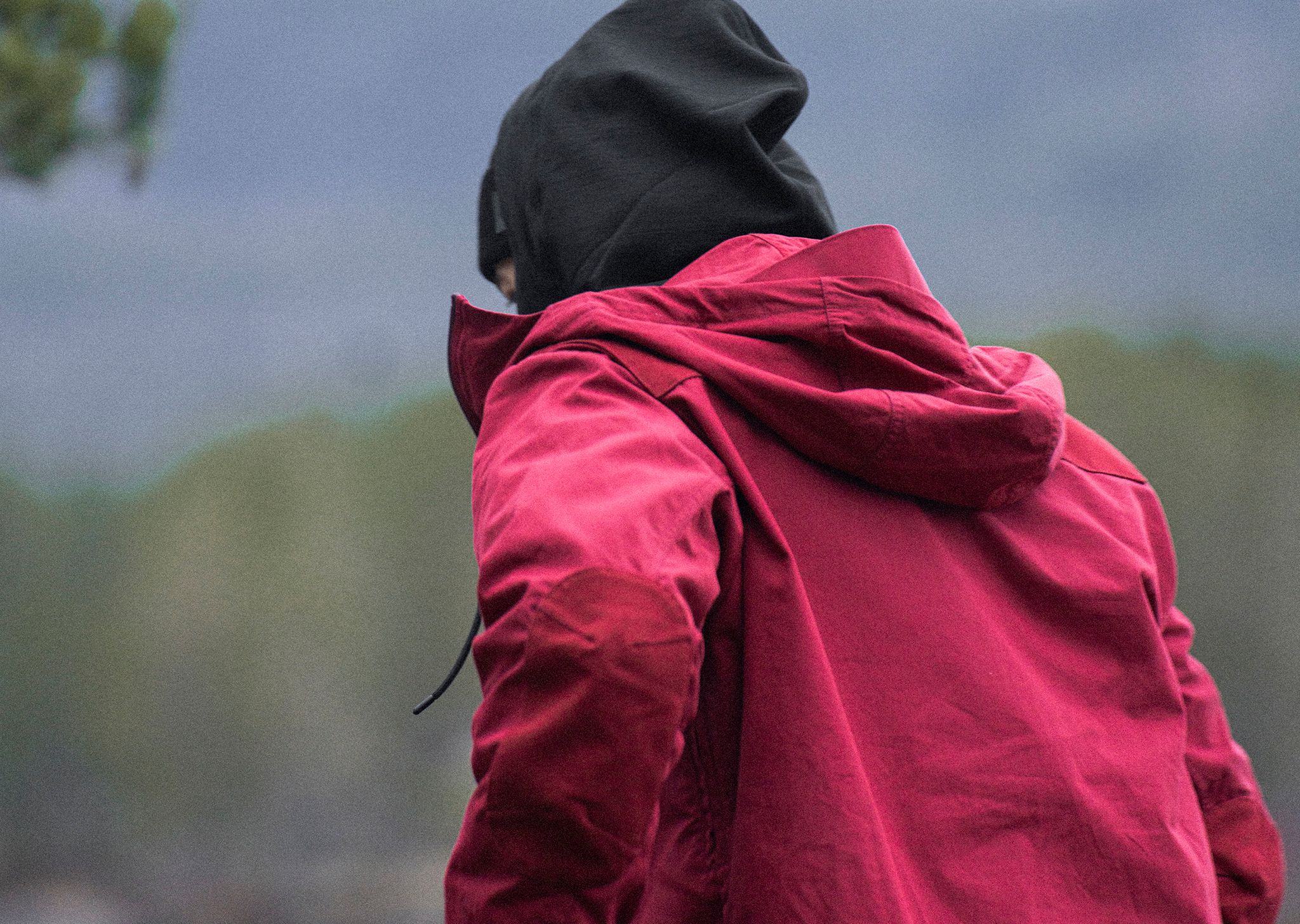 man outside with red jacket 