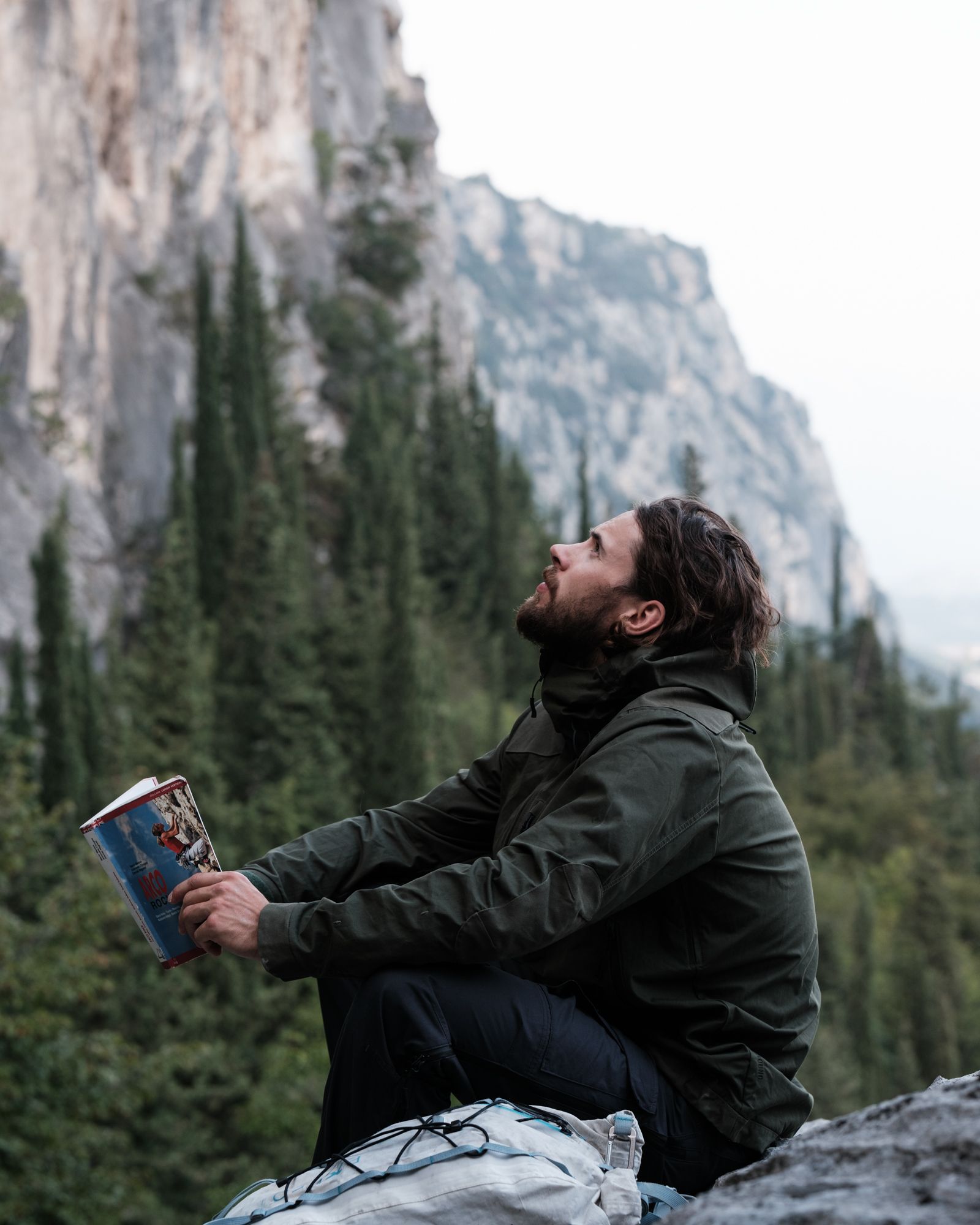 MAN IN GREEN JACKET WITH MOUNTAIN VIEW