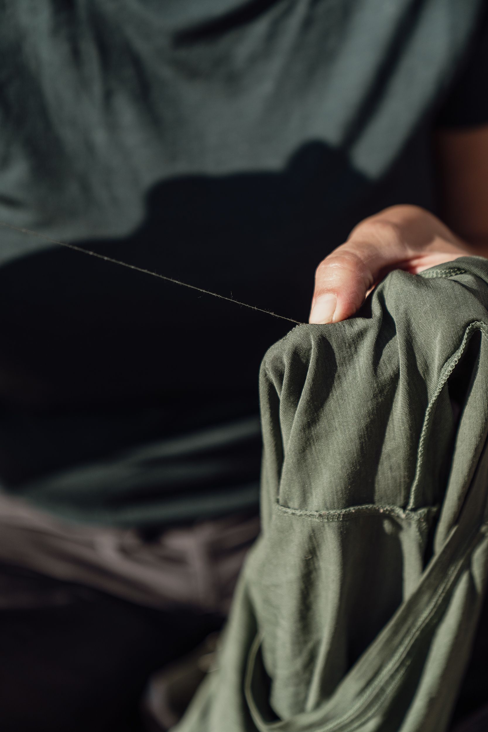 Lady sewing green sweater