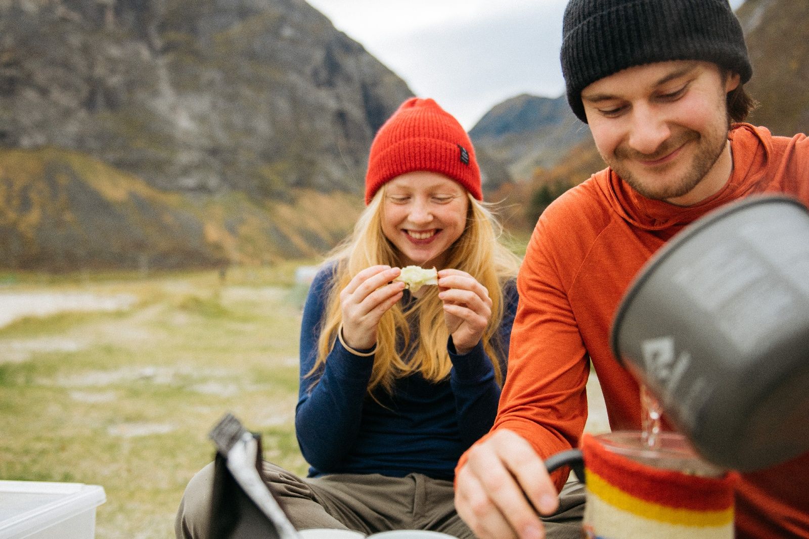 Man and woman sitting outside eating