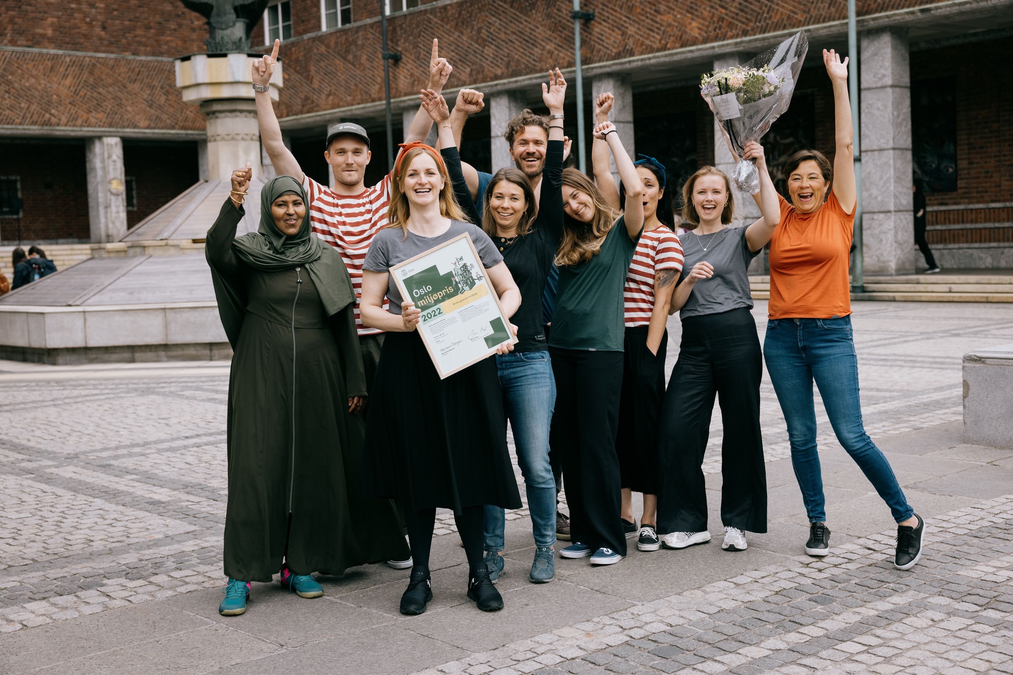 The NP team cheers in front of Oslo's town hall