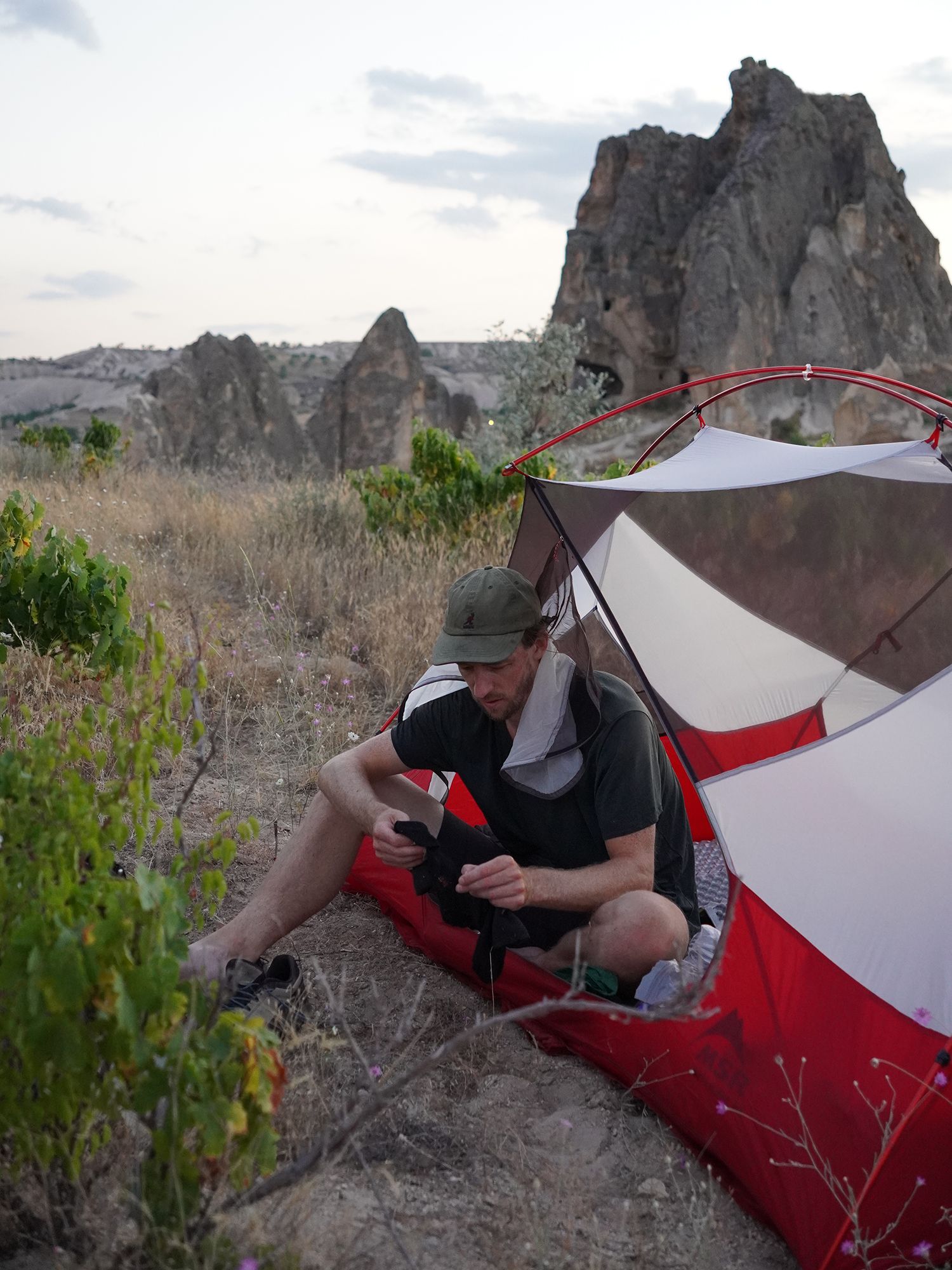 Resting in tent opening on a beautiful camp site