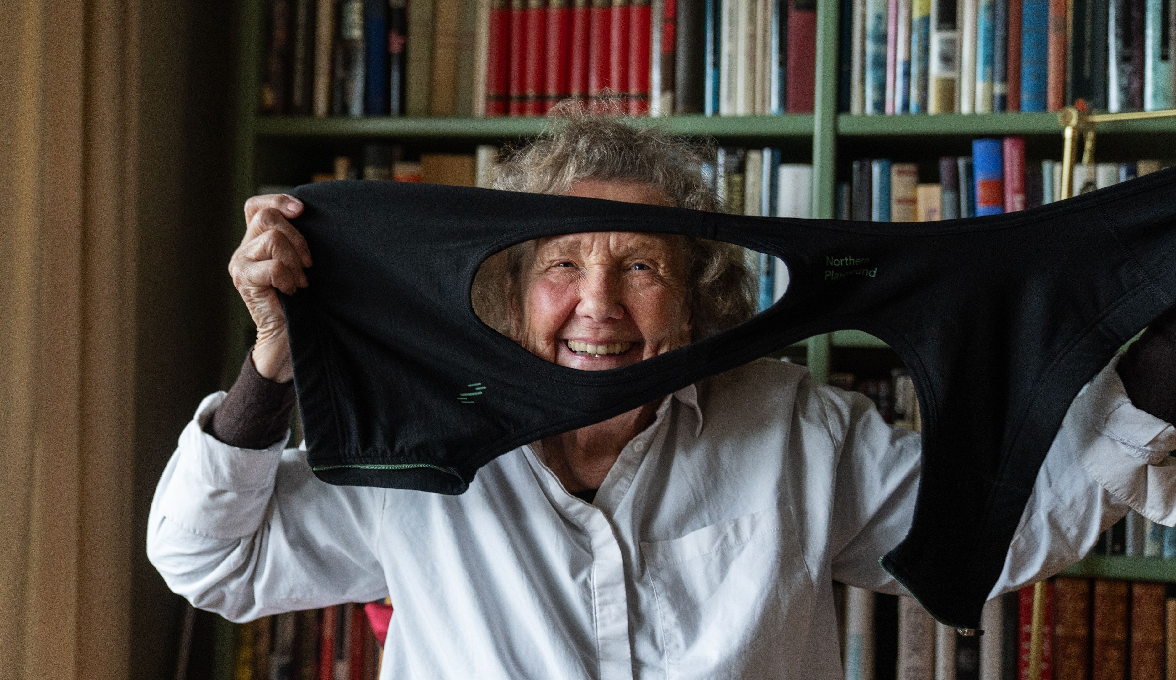 Grandma holding up a bra in front of face