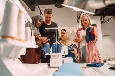 Photo of Jo and two other women sewing.