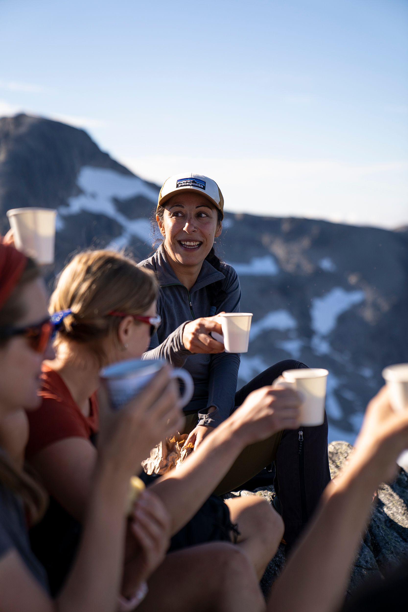 A group of people drinking coffee on top of a mountain