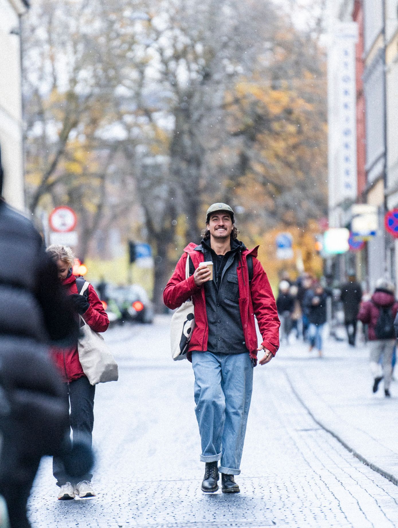 Man walking in the streets of Oslo in a red The Last Jacket