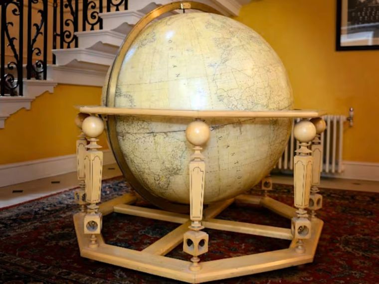 A finely-crafted wooden globe gifted to Lady Thatcher from French President Francois Mitterrand