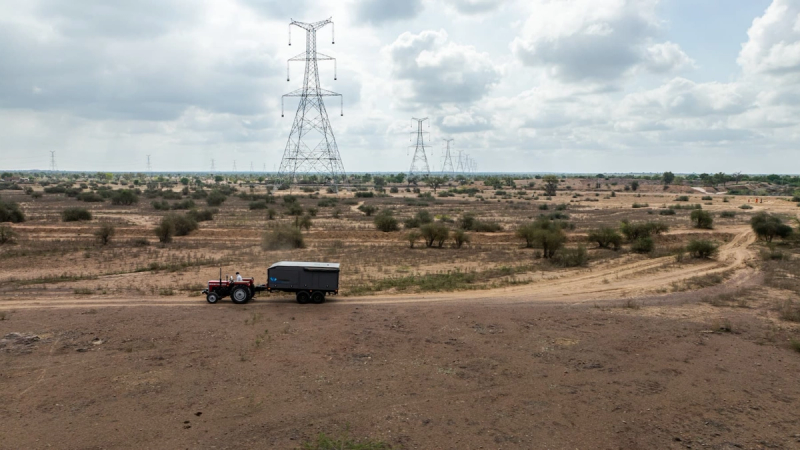 Transmission towers over a wide landscape, supporting rapid grid build-out.