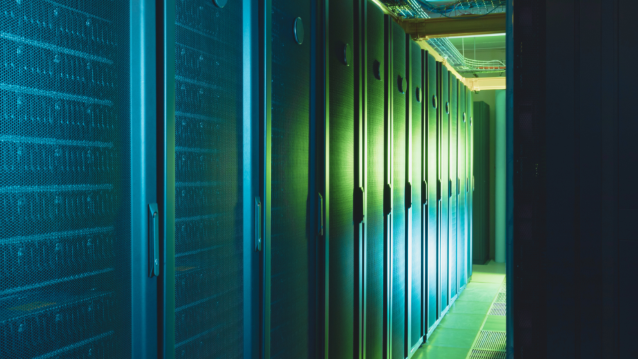 A row of illuminated server racks in a data centre.