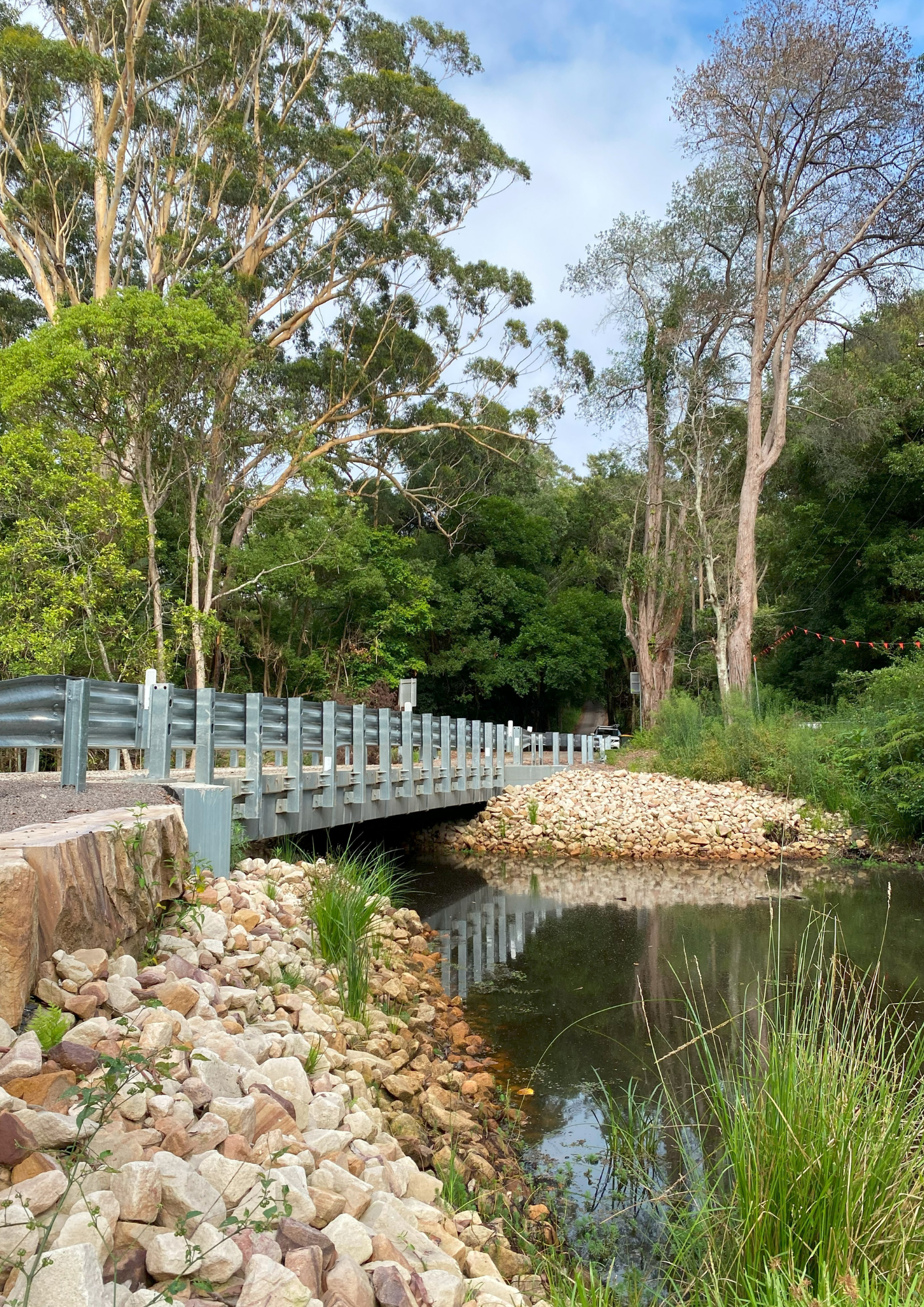 A small concrete bridge over a pond.
