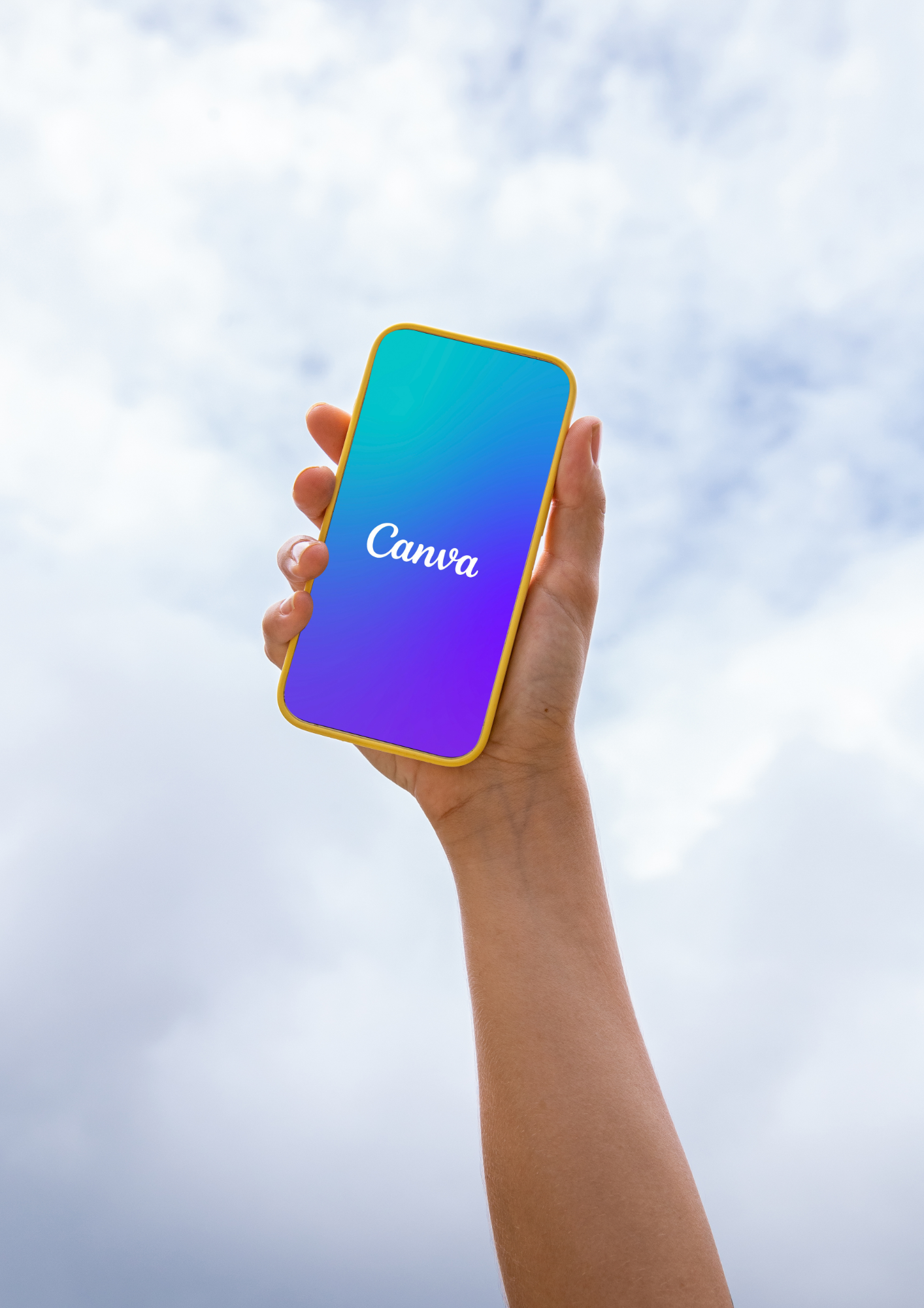Hand holding a phone showing the Canva screen against the sky.