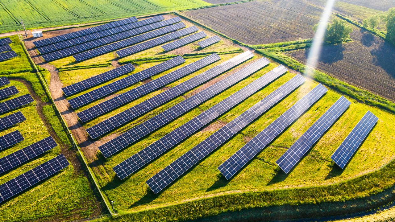 Solar farm rows viewed from above fields.
