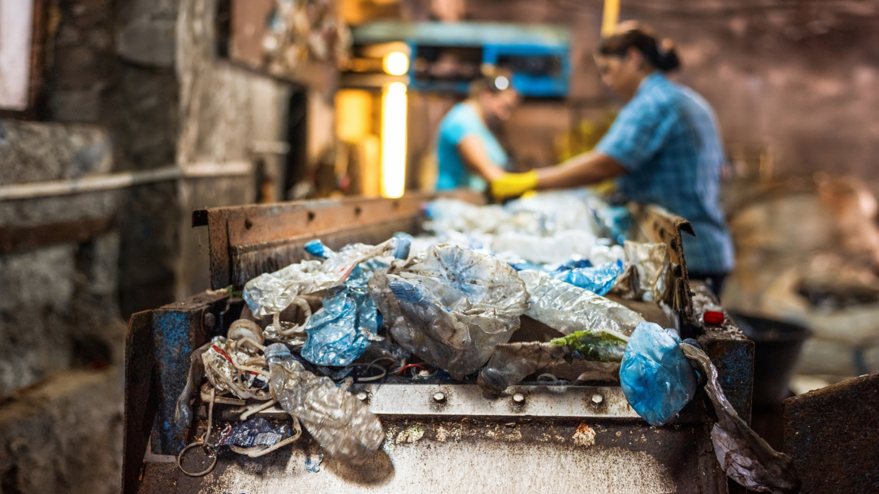 Workers sorting collected plastic waste for recycling.