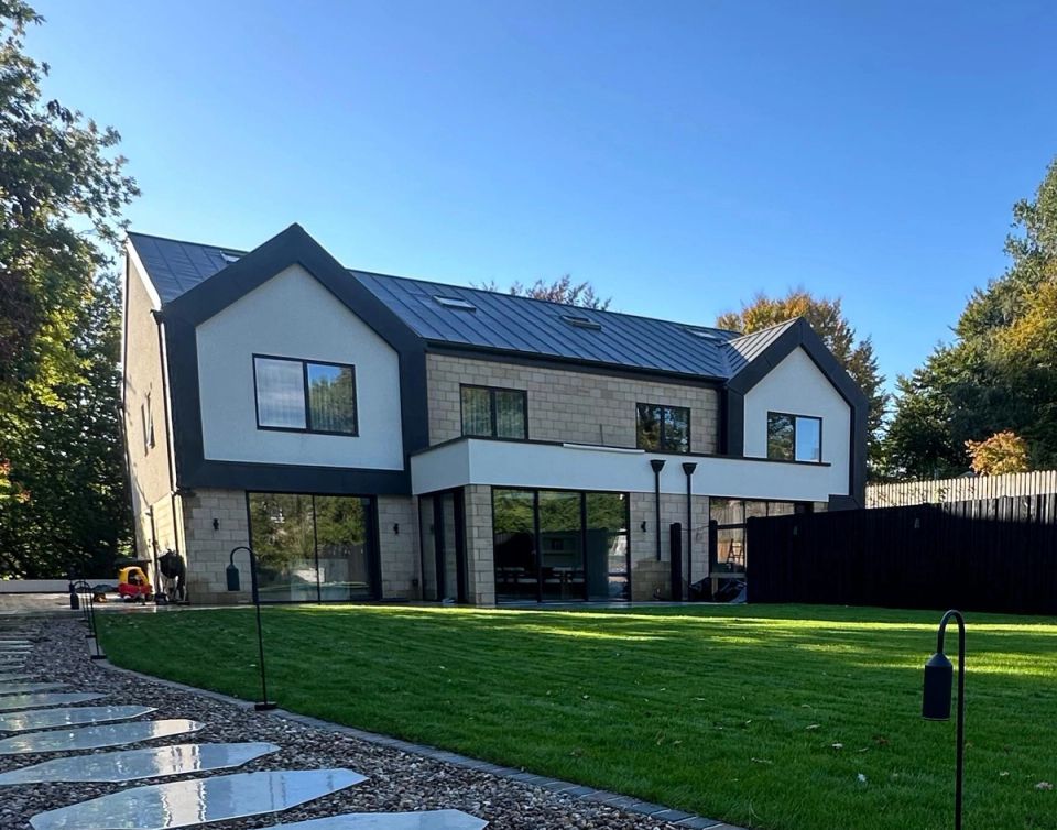 A completed residential new build with landscaped gardens.