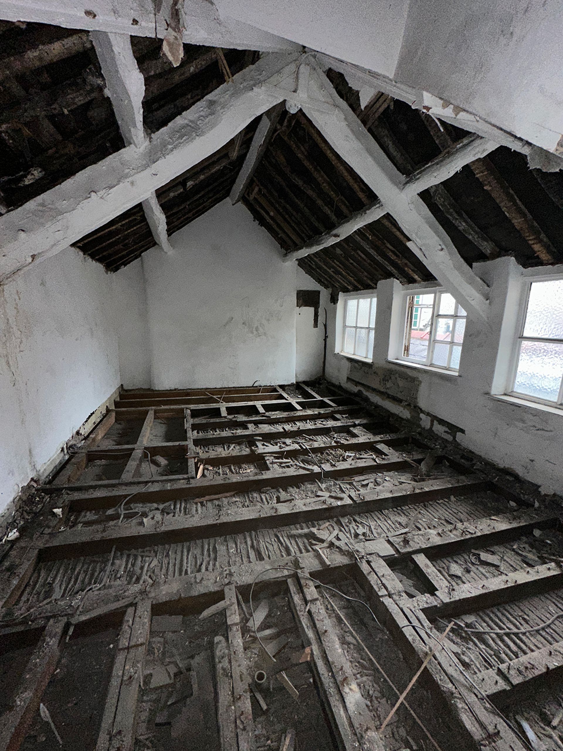 Exposed timber beams inside the building before restoration began.