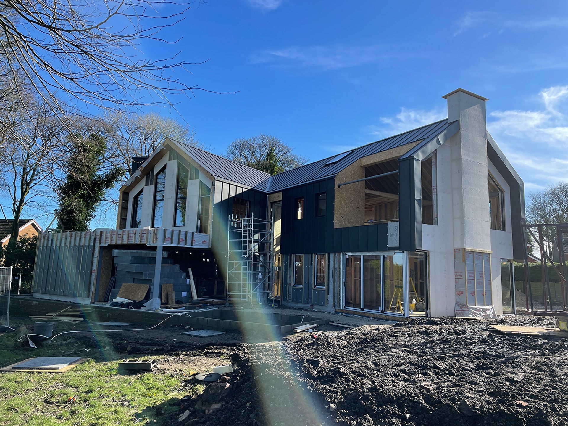 Cladding going on while the scaffold is still up.