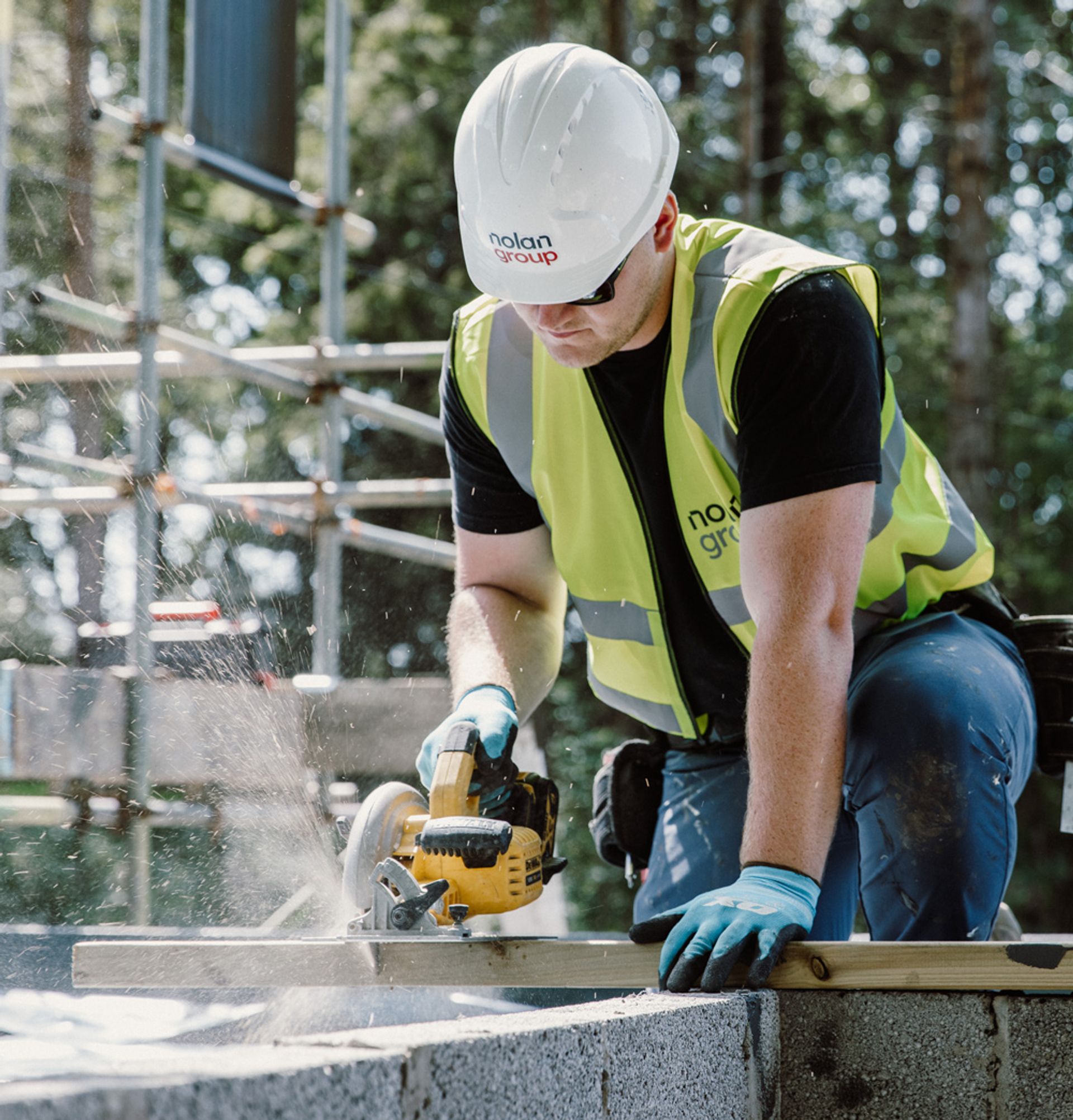 A joiner cutting timber on site.