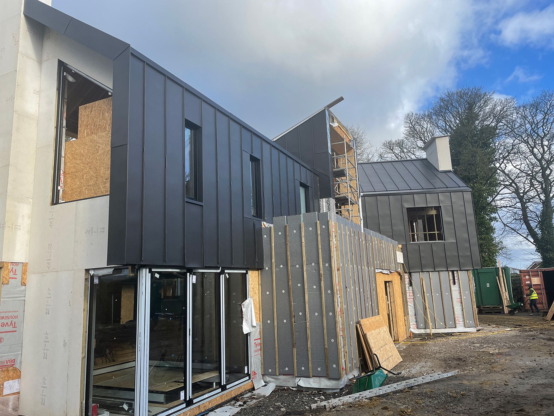 Exterior cladding being fixed to the upper elevation.