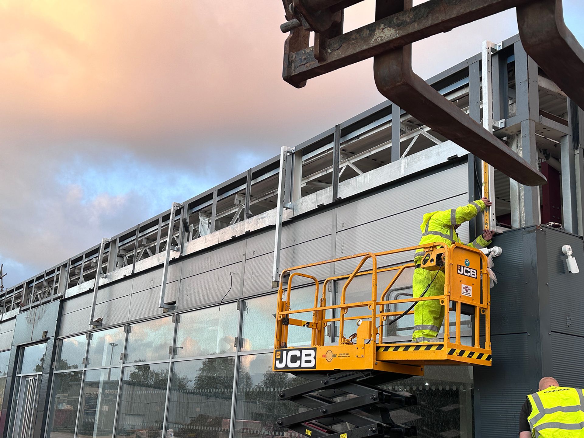 Trades working on the external cladding at Speke.