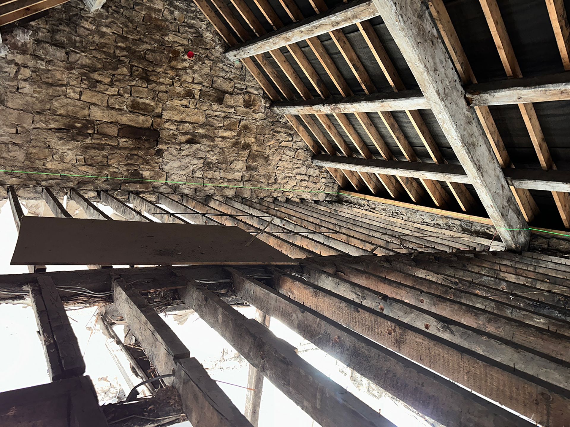 Historic beams and brickwork exposed before the conversion work.