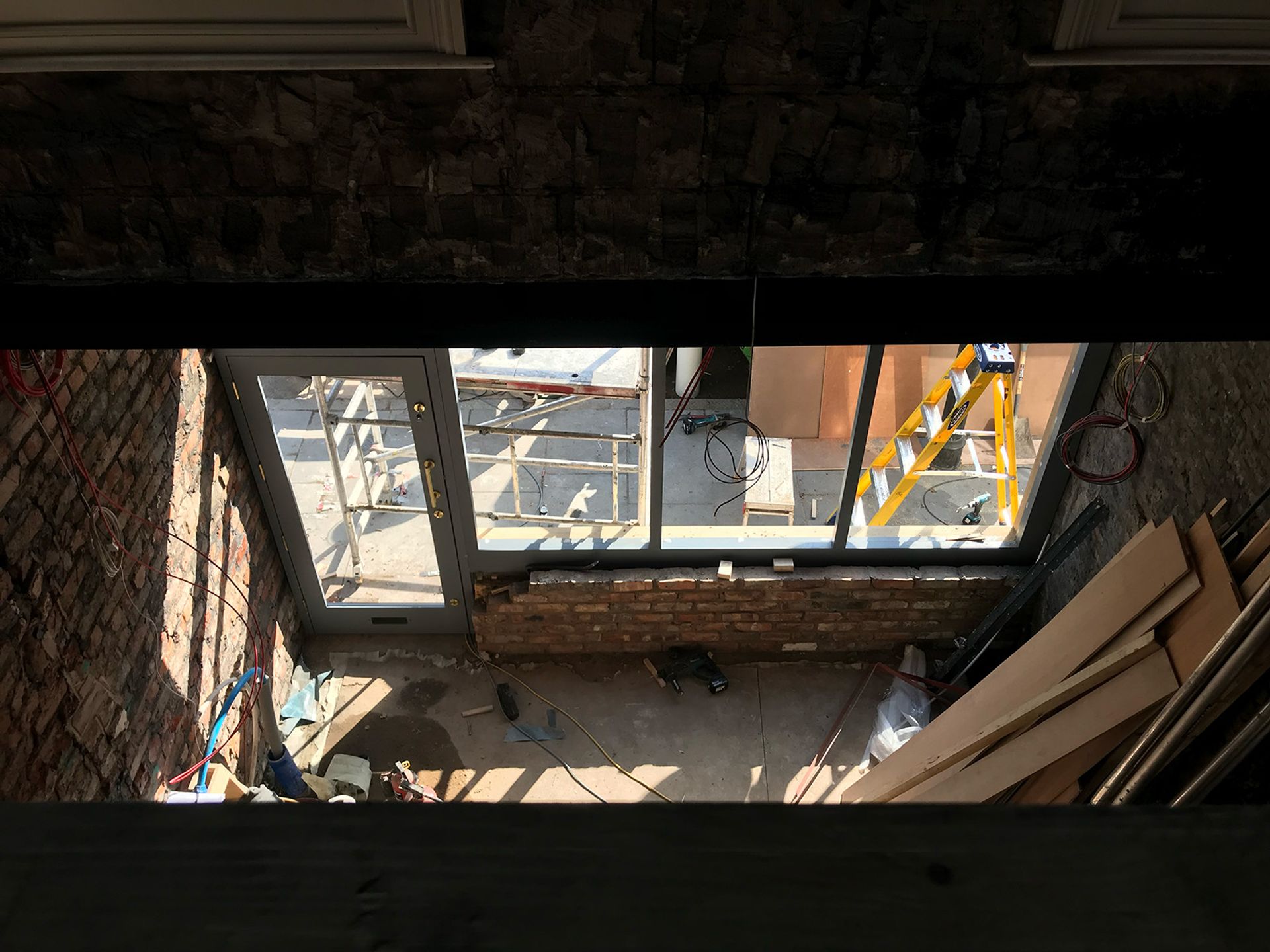 Looking down on the shopfront as the new glazing goes in.