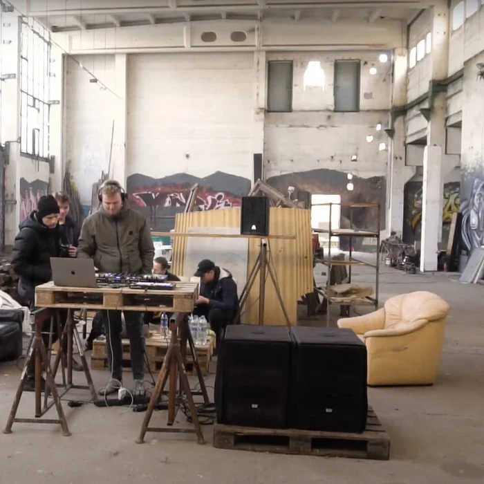 Young men djing in a warehouse space