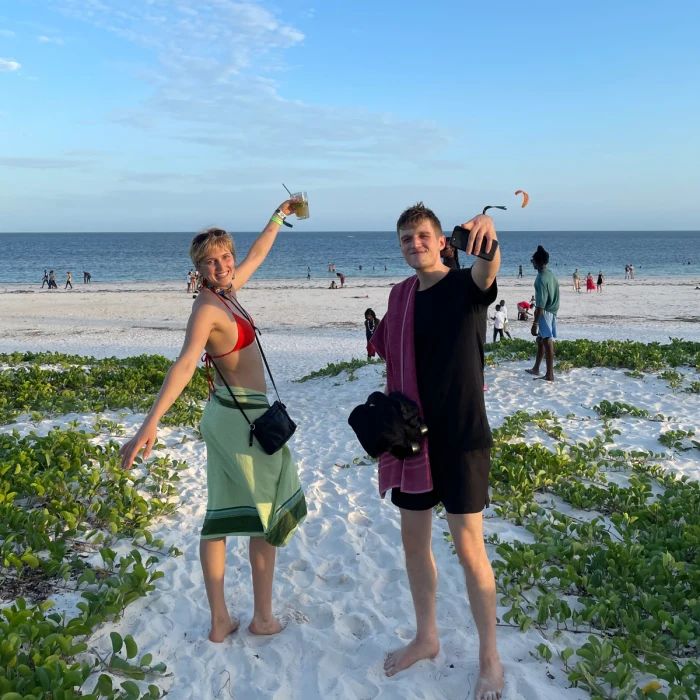 Two people on a beach smiling
